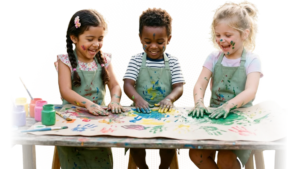 Children finger-painting in aprons at Kindred Kids